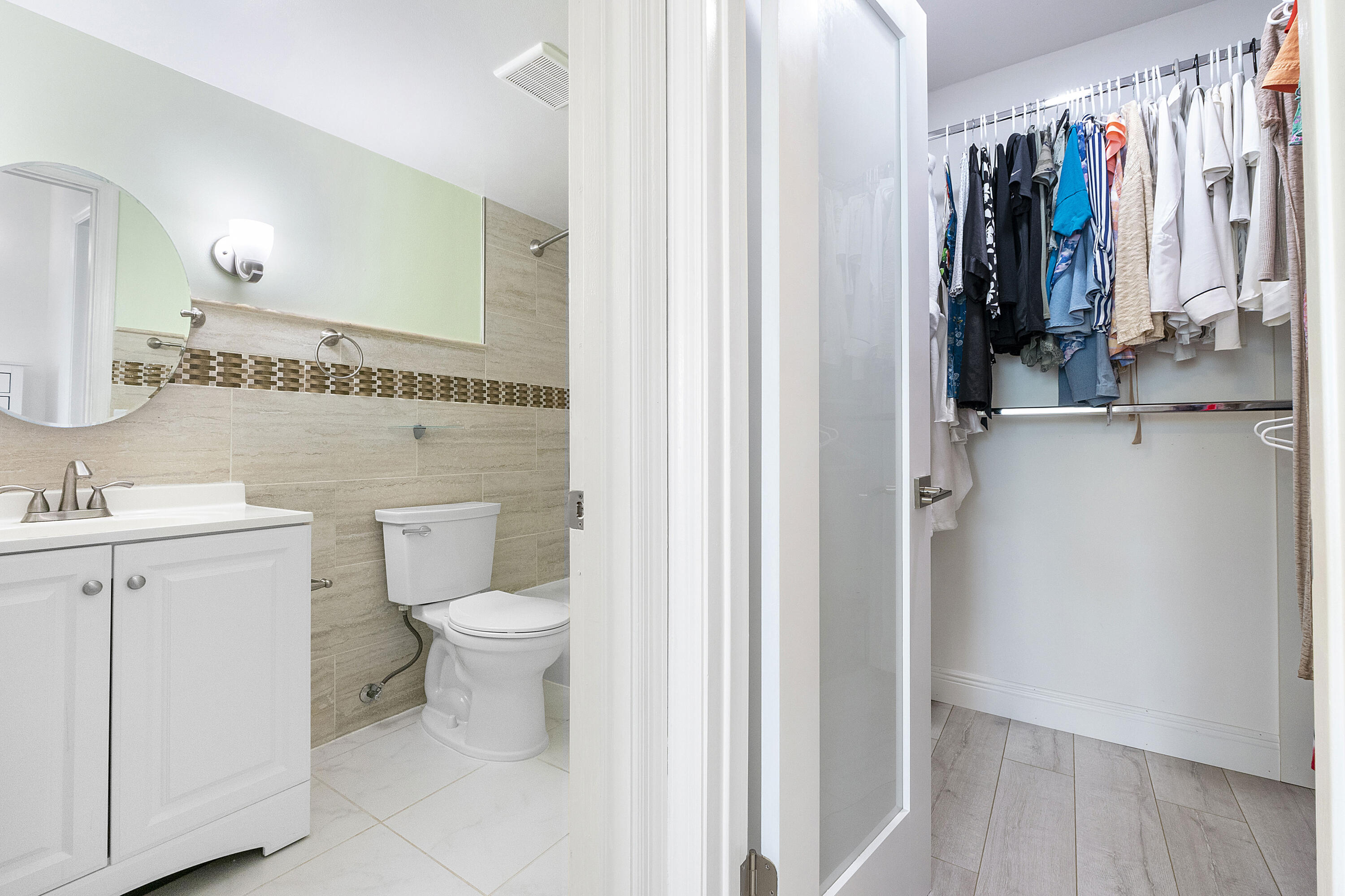1100 Northwest 13th Street, Unit 192D Boca Raton, FL 33486 - Photo 20 of 42 a bathroom with a toilet sink and mirror