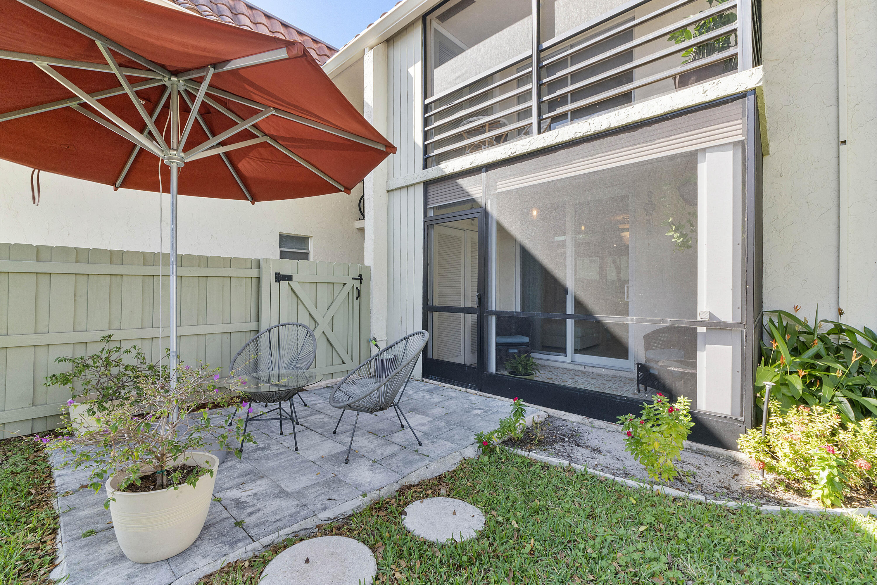 1100 Northwest 13th Street, Unit 192D Boca Raton, FL 33486 - Photo 2 of 42 a view of a chair and table of backyard with potted plants