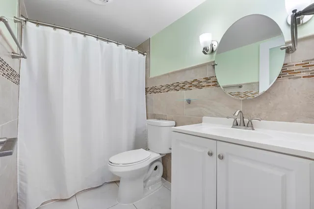 a bathroom with a sink mirror vanity and toilet