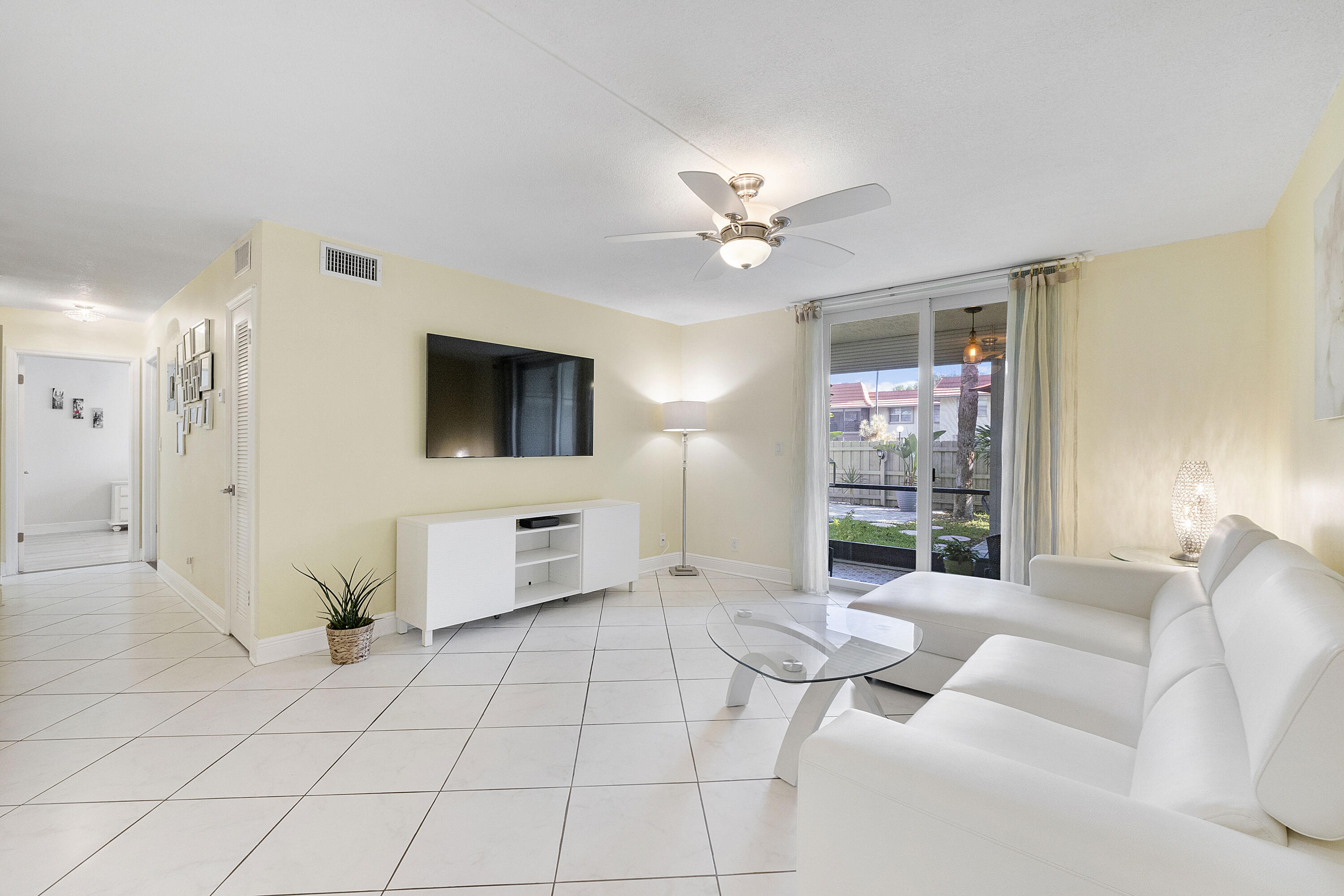 1100 Northwest 13th Street, Unit 192D Boca Raton, FL 33486 - Photo 25 of 42 a living room with furniture and a flat screen tv