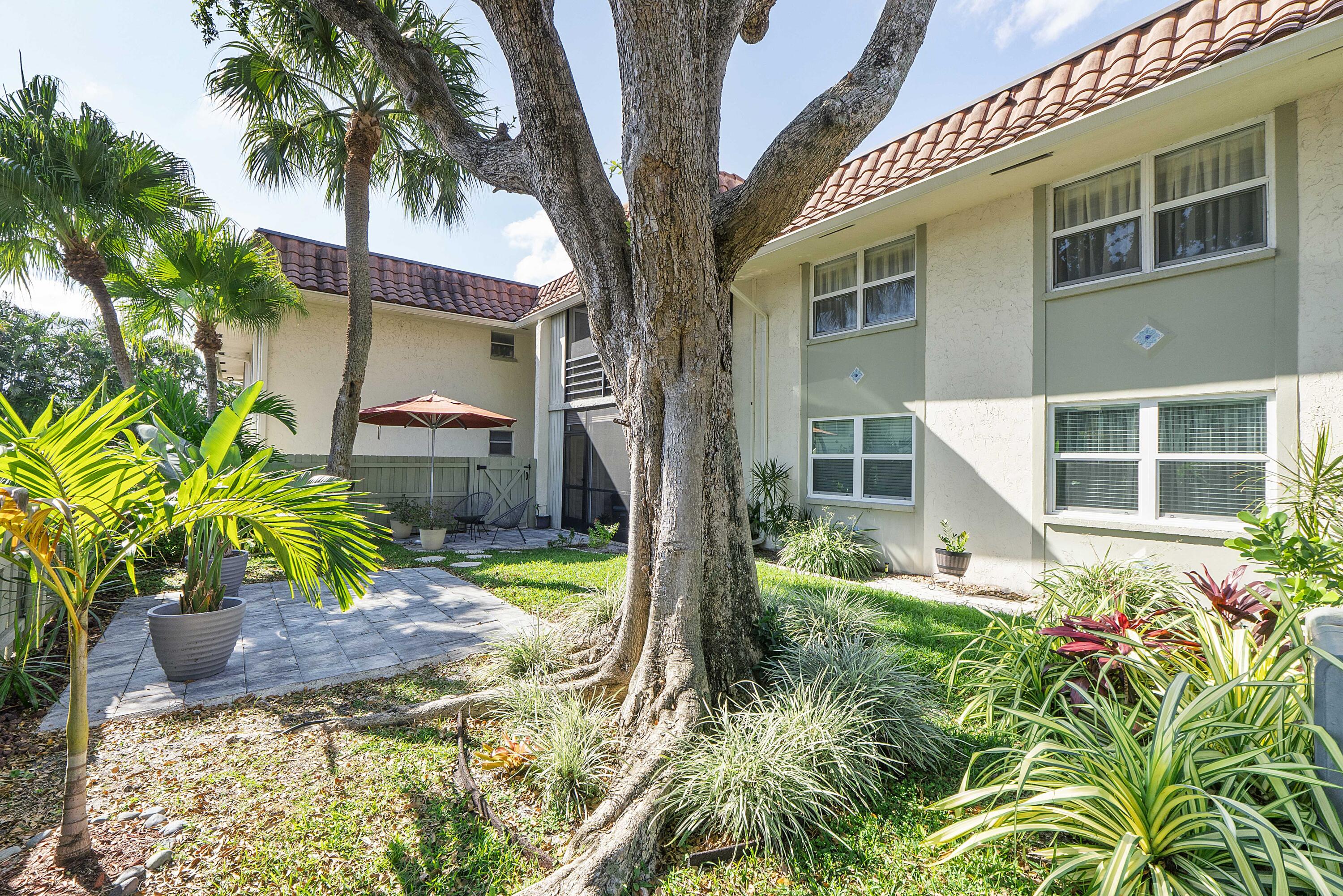 1100 Northwest 13th Street, Unit 192D Boca Raton, FL 33486 - Photo 26 of 42 a front view of a house with garden
