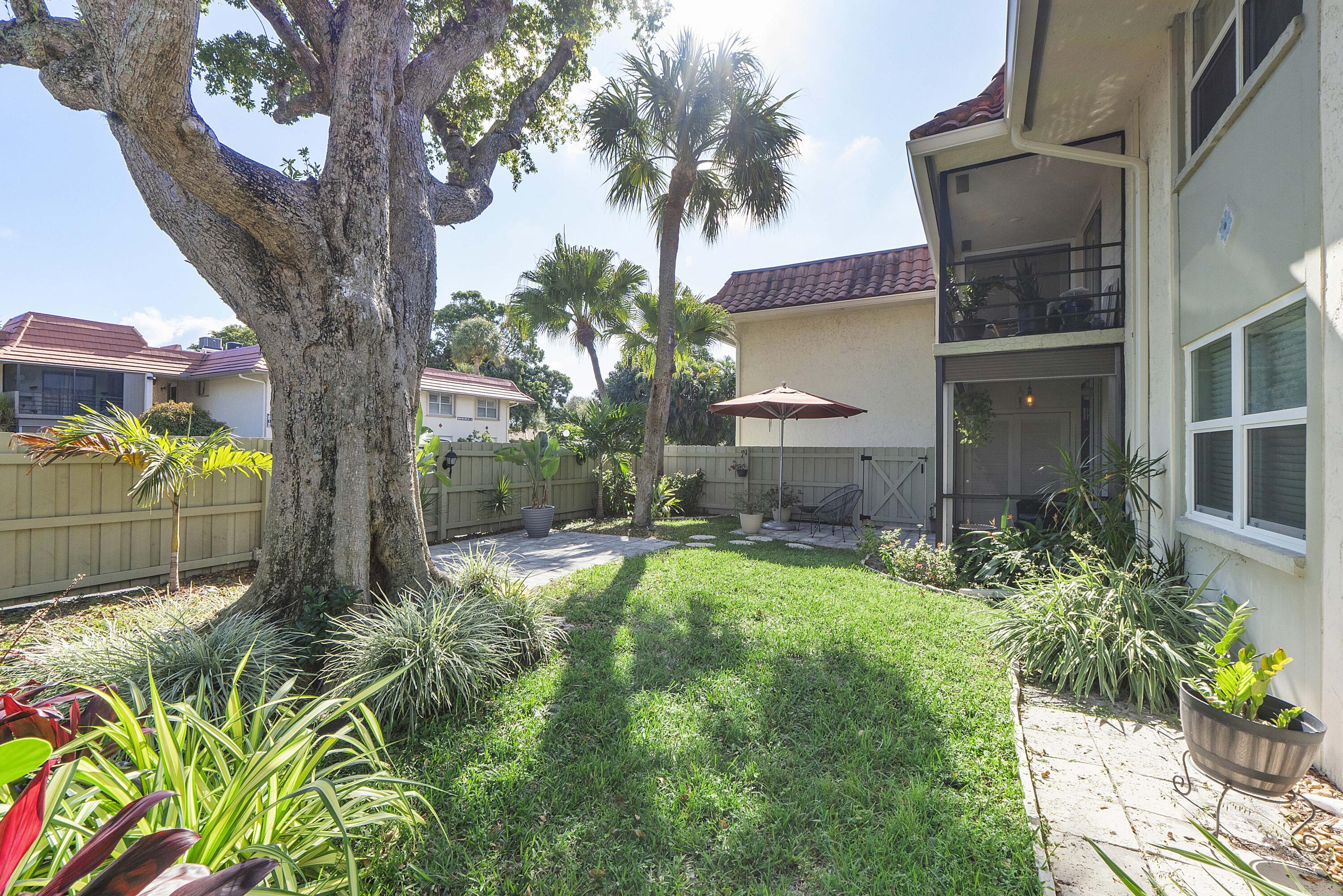 1100 Northwest 13th Street, Unit 192D Boca Raton, FL 33486 - Photo 28 of 42 a view of a house with a yard and potted plants