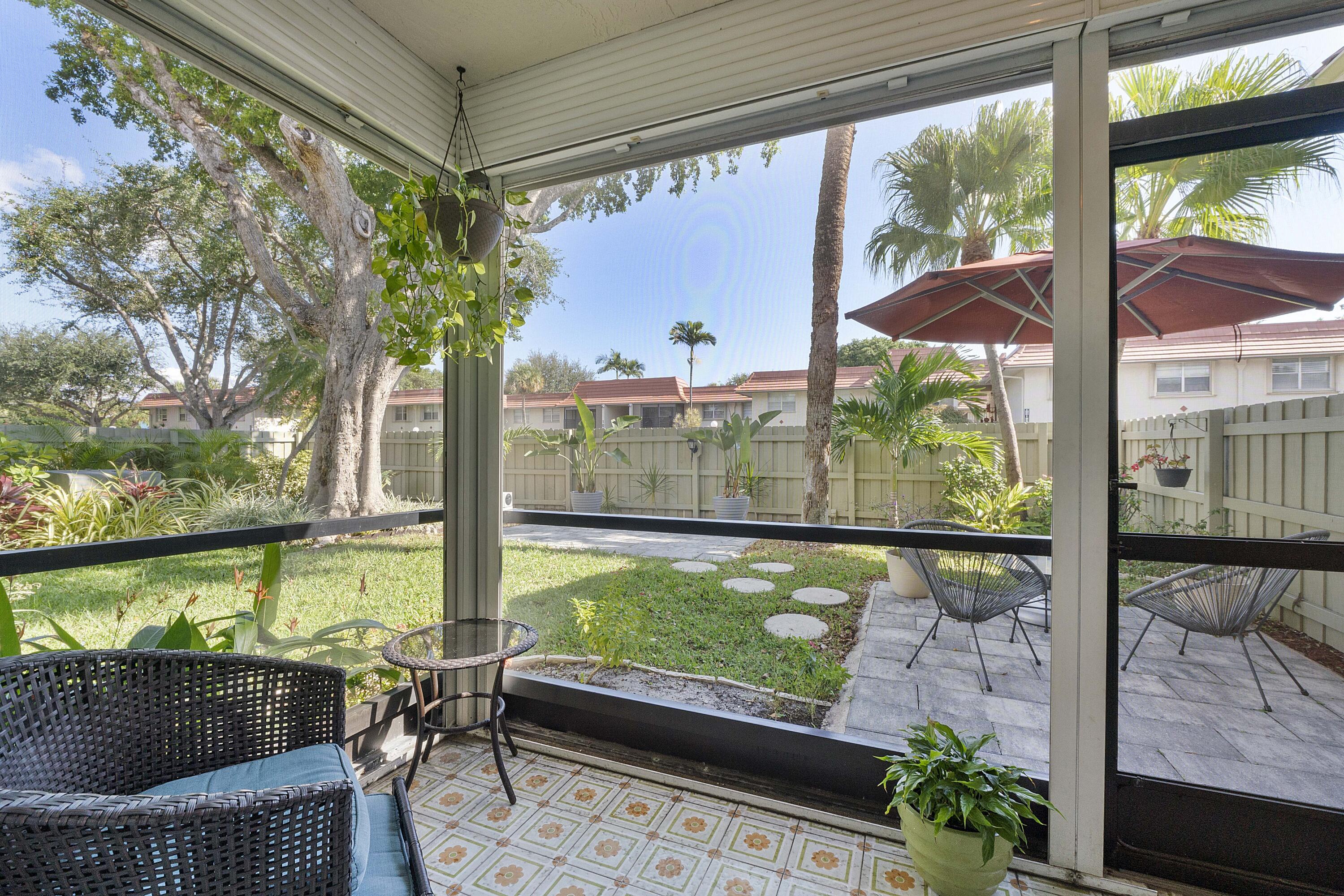 1100 Northwest 13th Street, Unit 192D Boca Raton, FL 33486 - Photo 3 of 42 a view of a porch with furniture