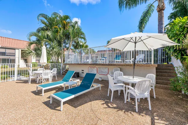 a view of a house with a backyard patio and swimming pool