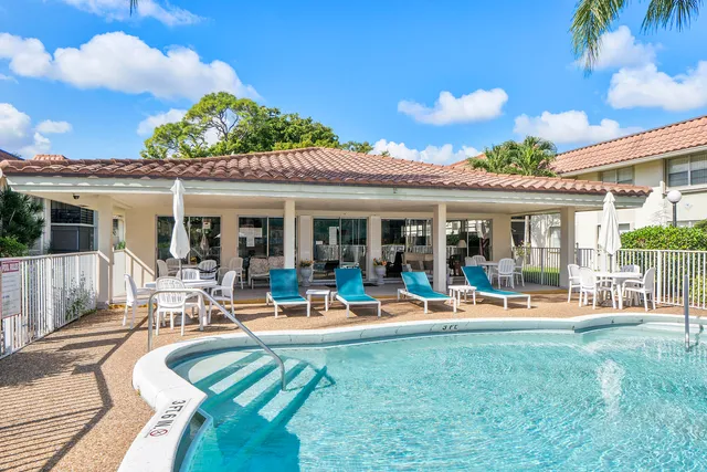 a living room with furniture a table and white walls