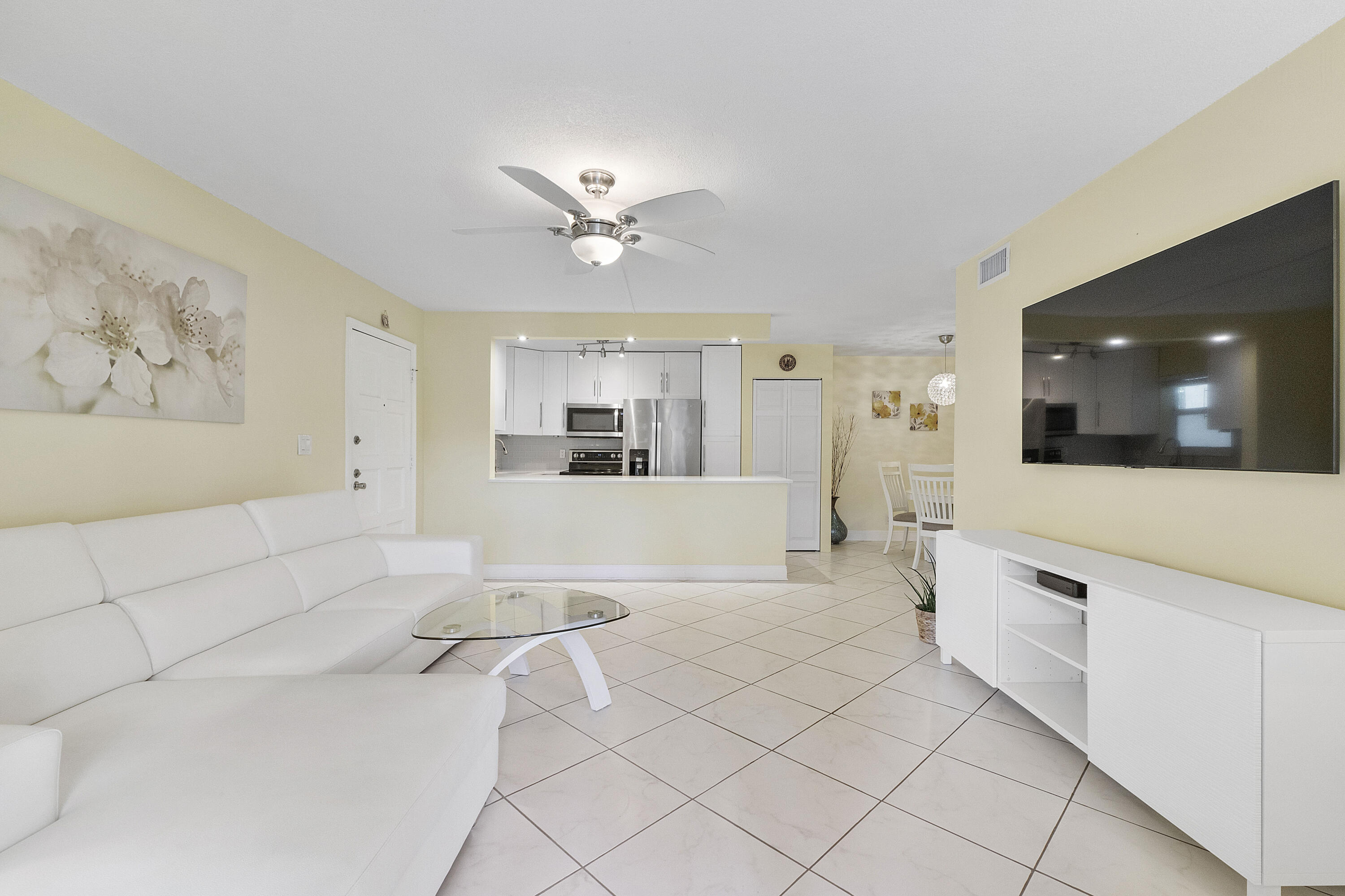 1100 Northwest 13th Street, Unit 192D Boca Raton, FL 33486 - Photo 5 of 42 a living room with furniture and a view of kitchen