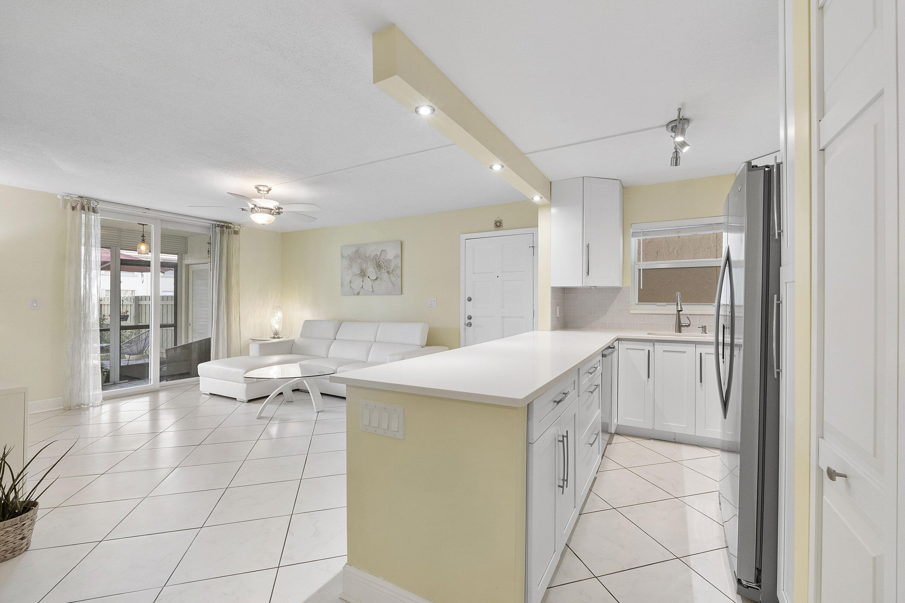 1100 Northwest 13th Street, Unit 192D Boca Raton, FL 33486 - Photo 7 of 42 a kitchen with a sink and chairs