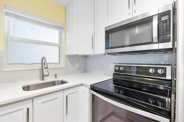 a kitchen with a stove and a microwave