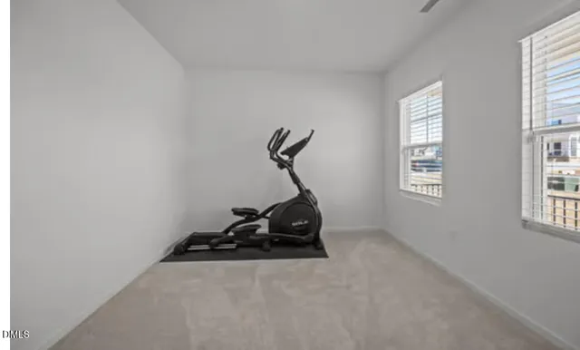 a room with gym equipment and windows