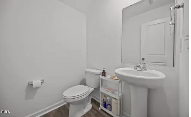 a bathroom with a sink a toilet and mirror