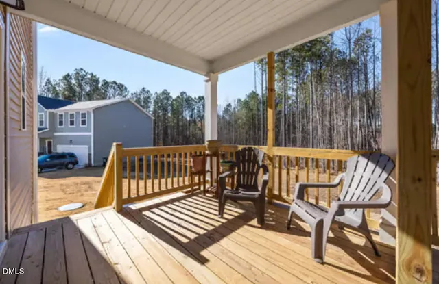 a view of balcony with wooden floor and outdoor seating