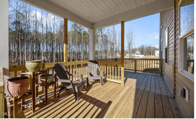 a view of balcony with wooden floor and outdoor seating