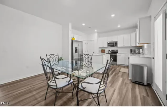 a view of a dining room with furniture and wooden floor