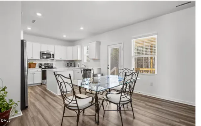 a view of a dining room with furniture and wooden floor