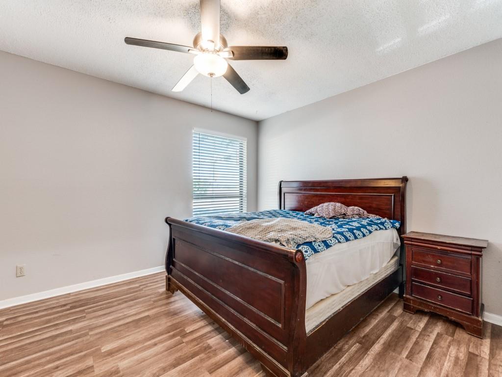 9250 Flickering Shadow Drive Dallas, TX 75243 - Photo 14 of 25 a bed sitting in a bedroom next to a window