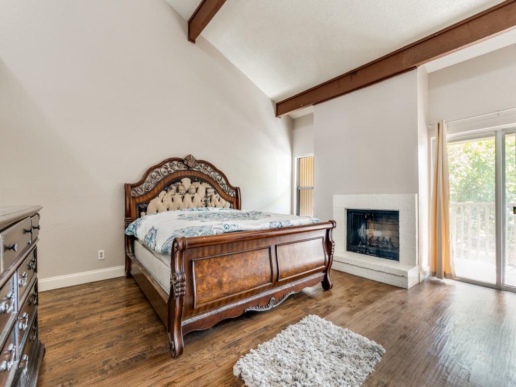 9250 Flickering Shadow Drive Dallas, TX 75243 - Photo 17 of 25 a bedroom with a bed and a fireplace