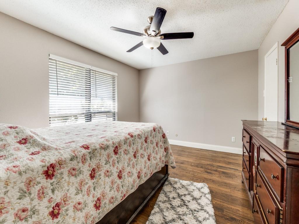 9250 Flickering Shadow Drive Dallas, TX 75243 - Photo 20 of 25 a bedroom with a bed and a window