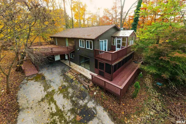 a blue swimming pool is sitting in the middle of a lake