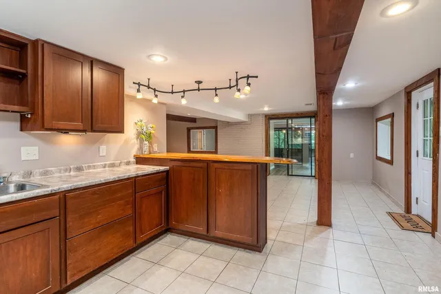 a view of a room with wooden floor and windows