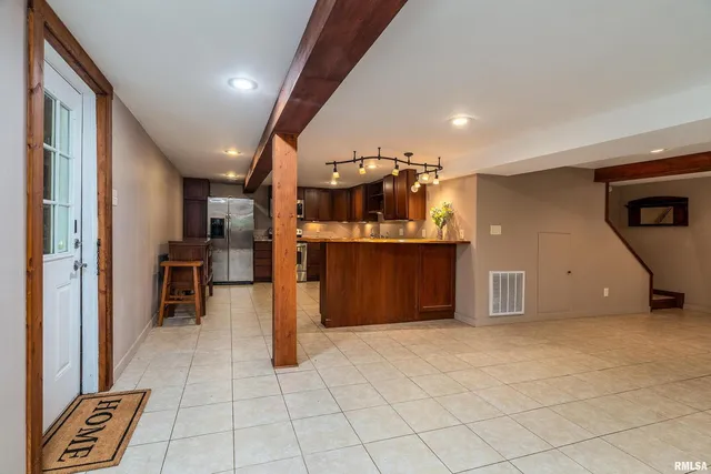 a kitchen with stainless steel appliances granite countertop a sink refrigerator and microwave