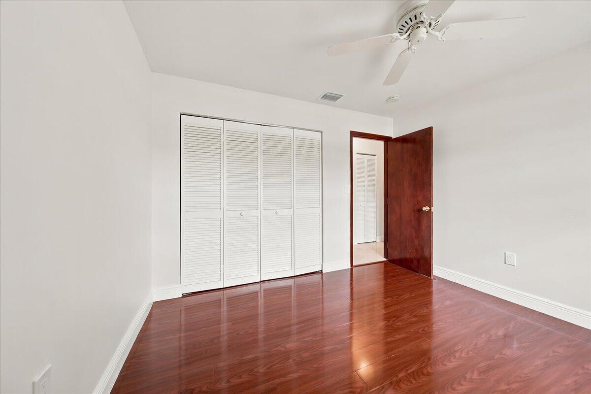 20009 Northwest 66th Place Hialeah, FL 33015 - Photo 28 of 33 an empty room with wooden floor and closet