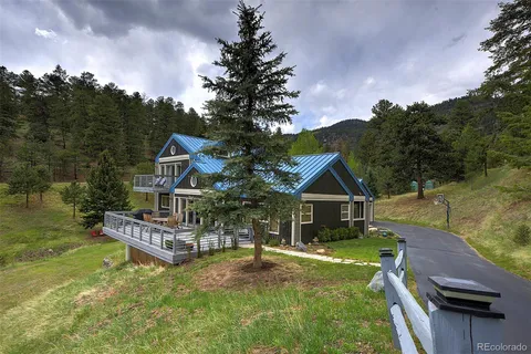 a view of house and outdoor space with yard