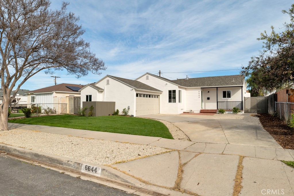 a view of house with yard and street view
