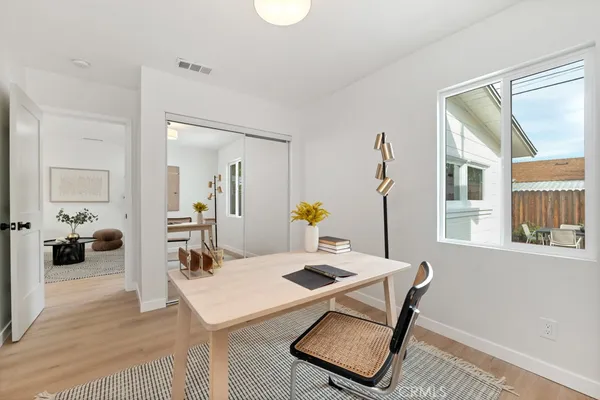 a bedroom with a bed and wooden floor