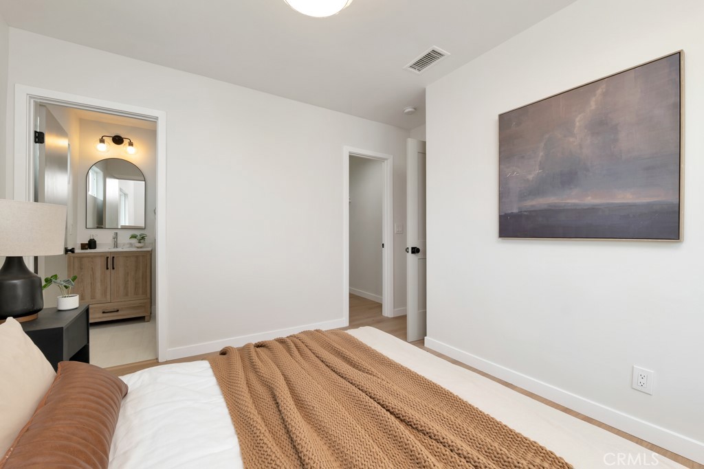 6644 Bothwell Road Reseda, CA 91335 - Photo 16 of 29 a bedroom with a bed and wooden floor