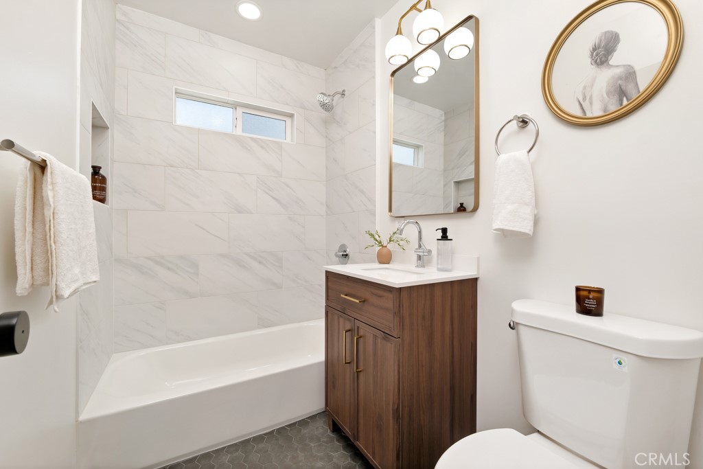 6644 Bothwell Road Reseda, CA 91335 - Photo 20 of 29 a bathroom with a bathtub a sink and a mirror