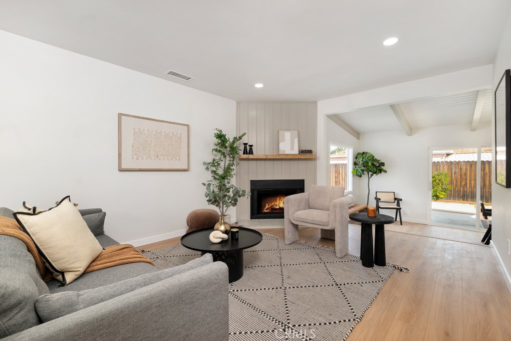 6644 Bothwell Road Reseda, CA 91335 - Photo 4 of 29 a living room with furniture a fireplace and a table