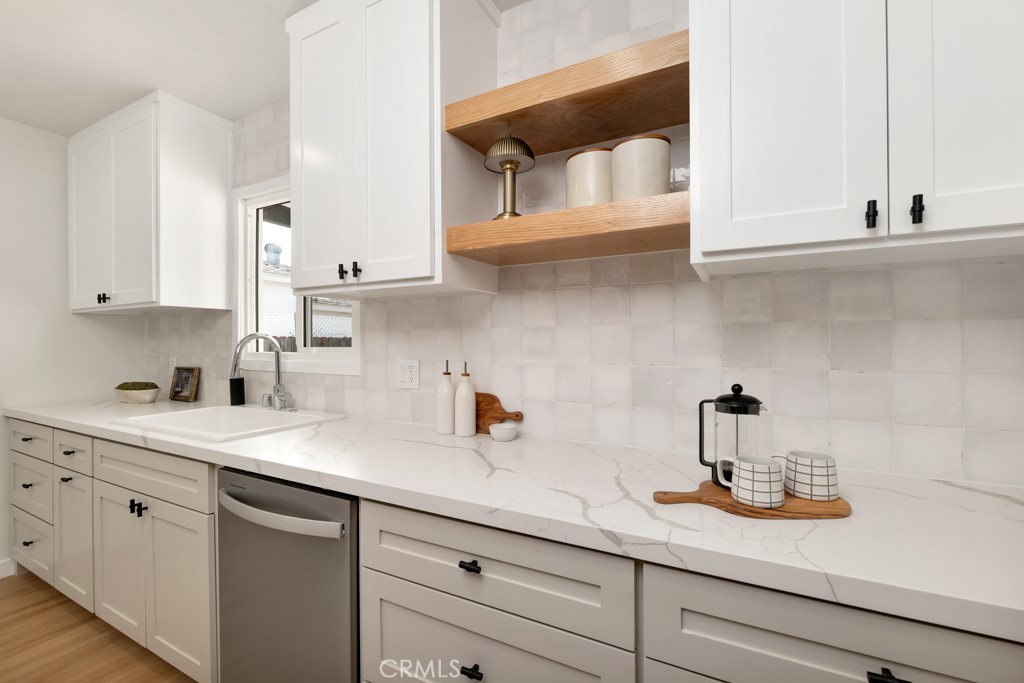 6644 Bothwell Road Reseda, CA 91335 - Photo 10 of 29 a kitchen with white cabinets and a sink
