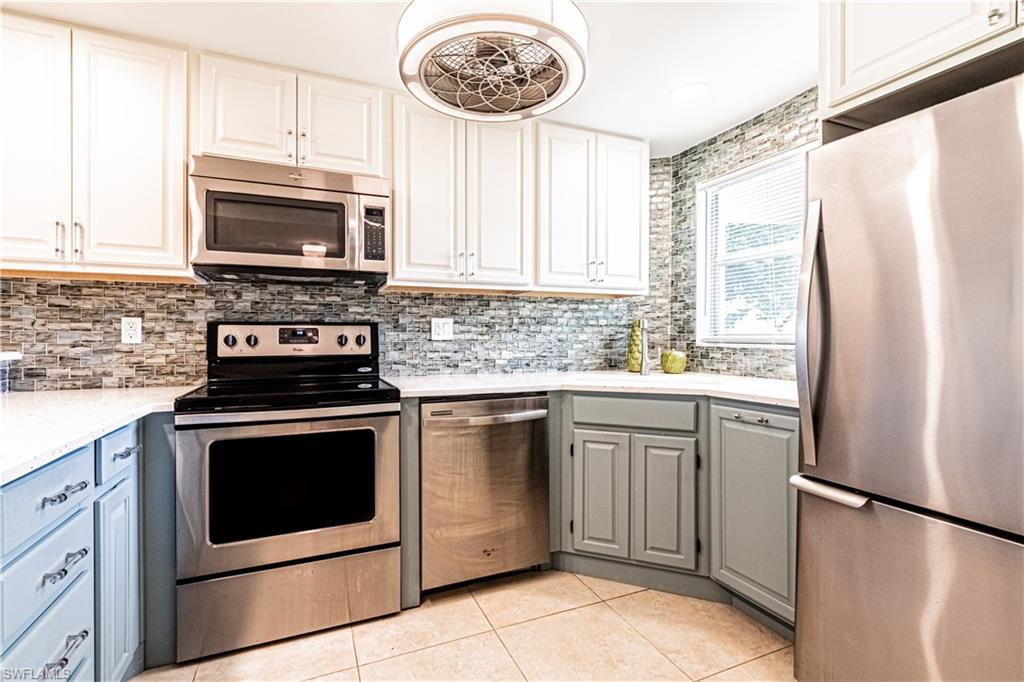 a kitchen with stainless steel appliances a stove a sink and a microwave