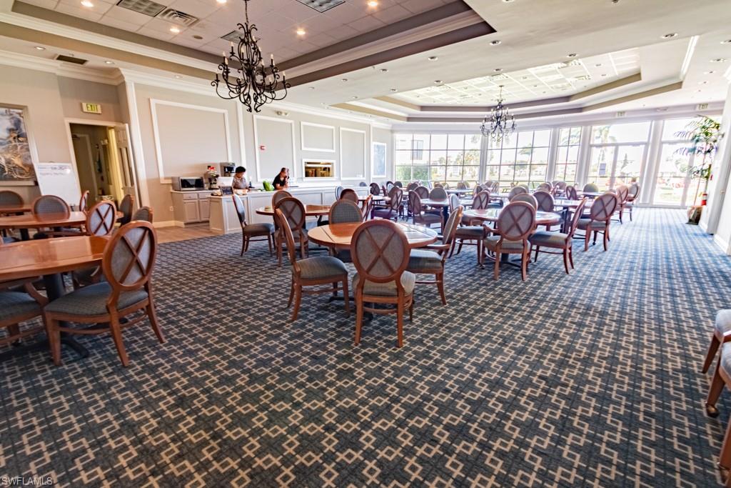 1 High Point Circle West, Unit 102 Naples, FL 34103 - Photo 22 of 35 a view of a dining room with furniture