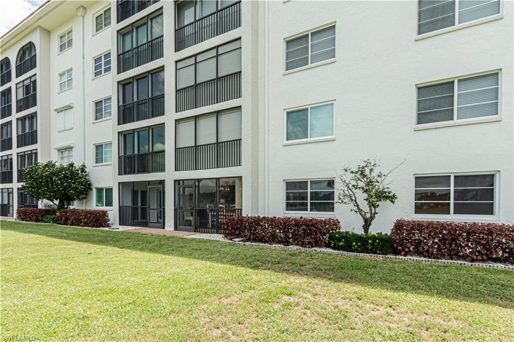 1 High Point Circle West, Unit 102 Naples, FL 34103 - Photo 28 of 35 a house view with a garden space