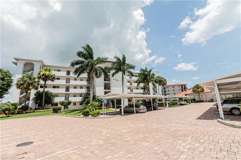 1 High Point Circle West, Unit 102 Naples, FL 34103 - Photo 35 of 35 a car parked in front of a building