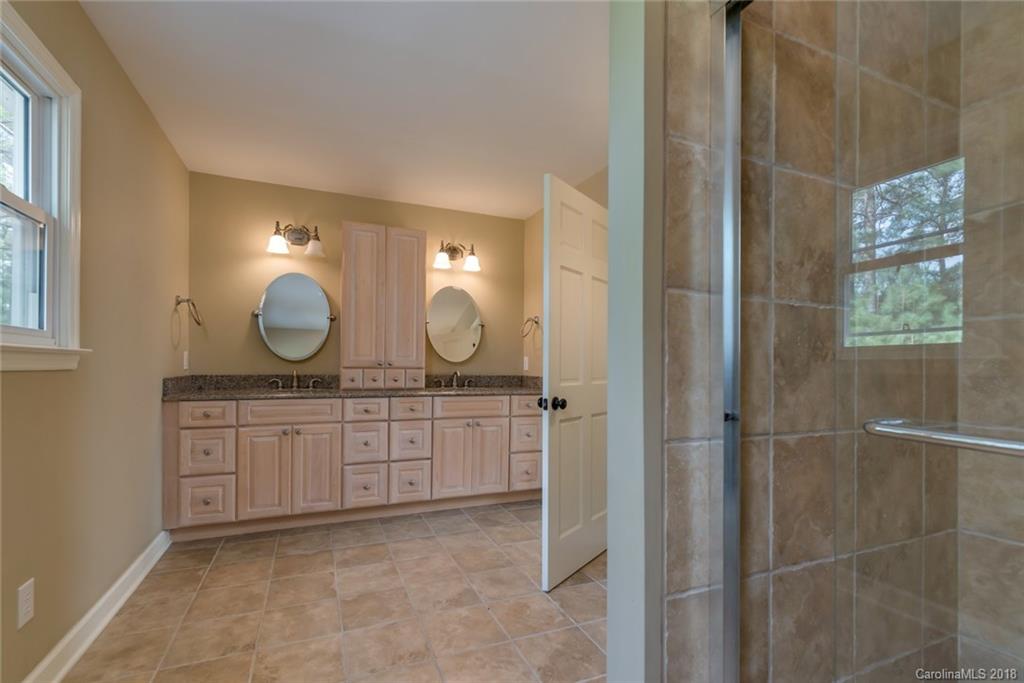 9990 New Cut Road Campobello, SC 29322 - Photo 17 of 31 a large bathroom with a double vanity sink and a mirror