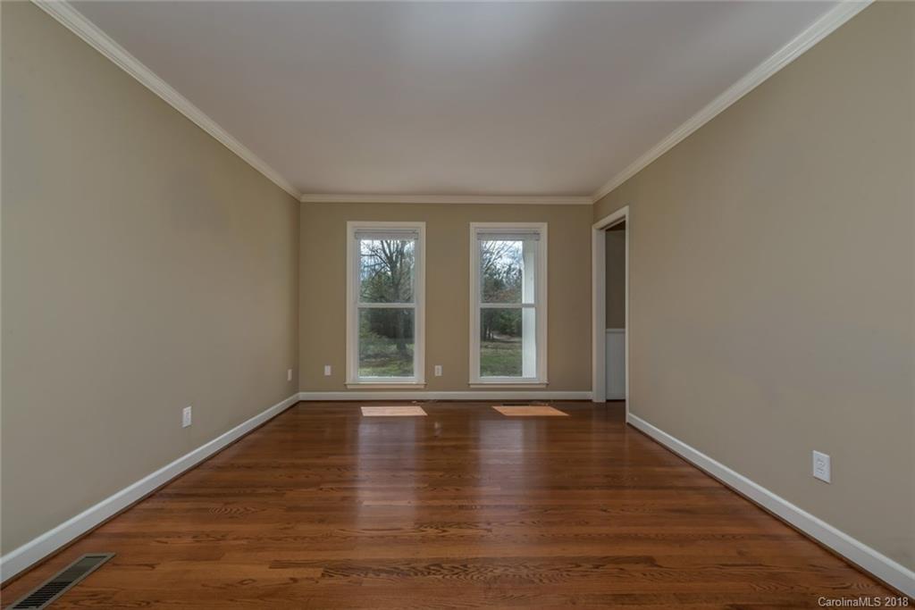 9990 New Cut Road Campobello, SC 29322 - Photo 7 of 31 a view of an empty room with wooden floor and a window