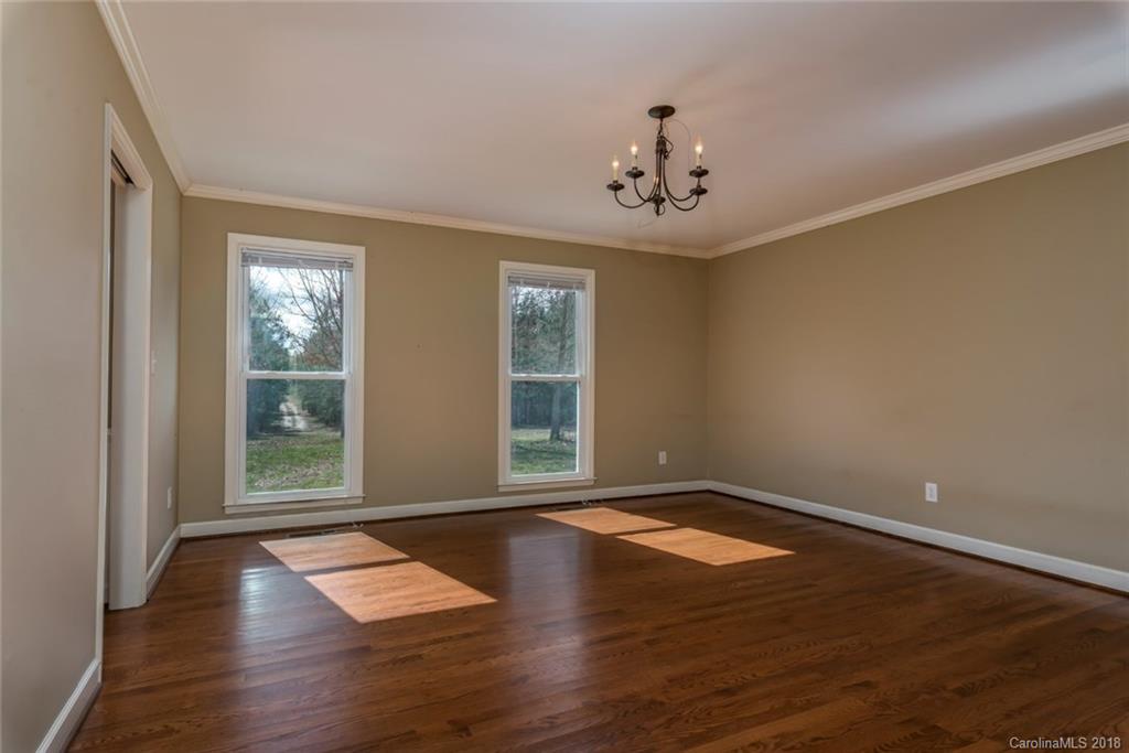 9990 New Cut Road Campobello, SC 29322 - Photo 8 of 31 a view of an empty room with wooden floor and a window