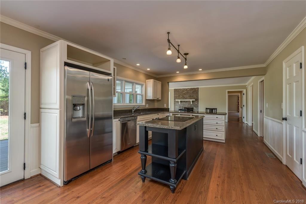 9990 New Cut Road Campobello, SC 29322 - Photo 10 of 31 a kitchen with kitchen island a counter top space a sink and stainless steel appliances