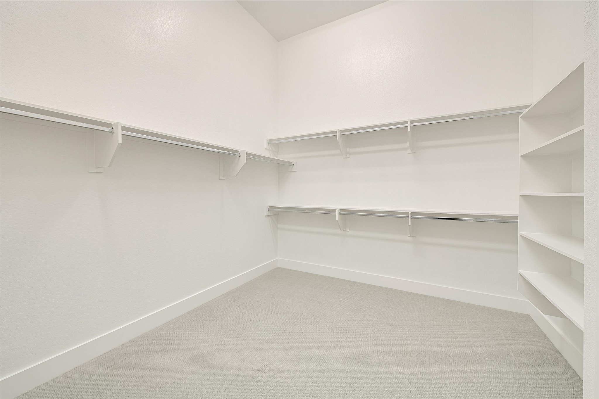 6136 Florencia Lane Austin, TX 78724 - Photo 15 of 40 One of Two Walk in closets with light colored carpet in Primary Bedroom/Bathroom