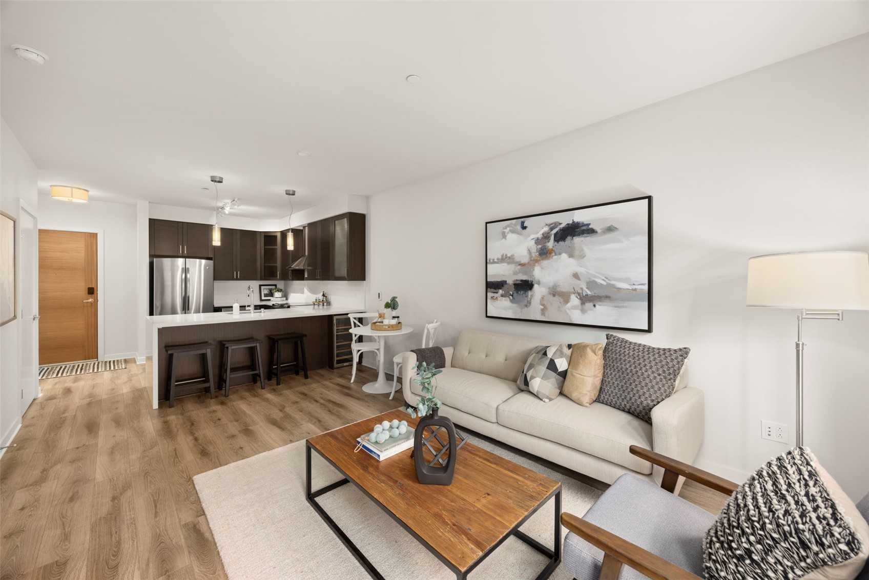 1760 Northwest 56th Street, Unit 309 Seattle, WA 98107 - Photo 15 of 35 a living room with furniture and a dining table with kitchen view