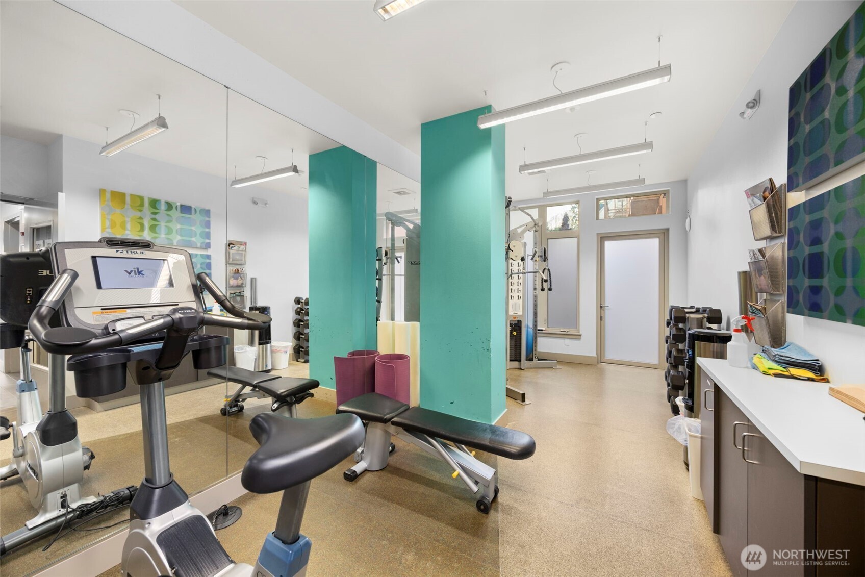 1760 Northwest 56th Street, Unit 309 Seattle, WA 98107 - Photo 27 of 35 a room with furniture and gym equipment