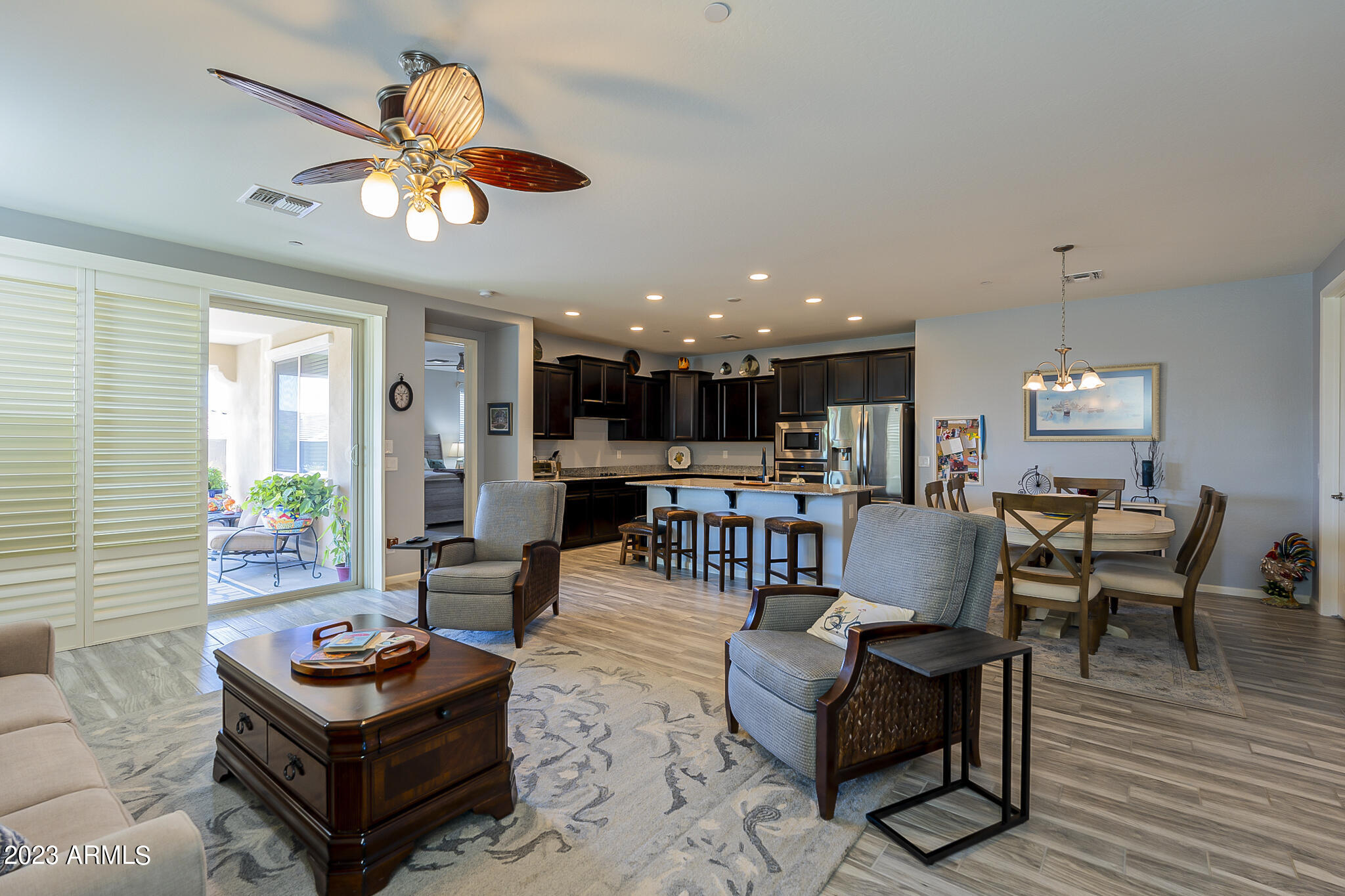 13719 West Linanthus Road Peoria, AZ 85383 - Photo 14 of 38 a living room with furniture kitchen view and a chandelier