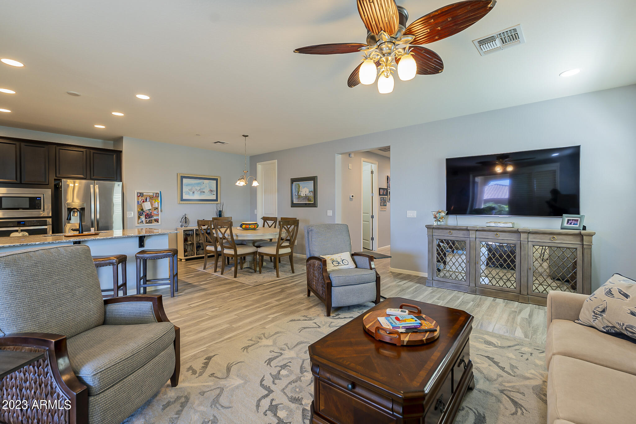 13719 West Linanthus Road Peoria, AZ 85383 - Photo 15 of 38 a living room with furniture kitchen view and a flat screen tv