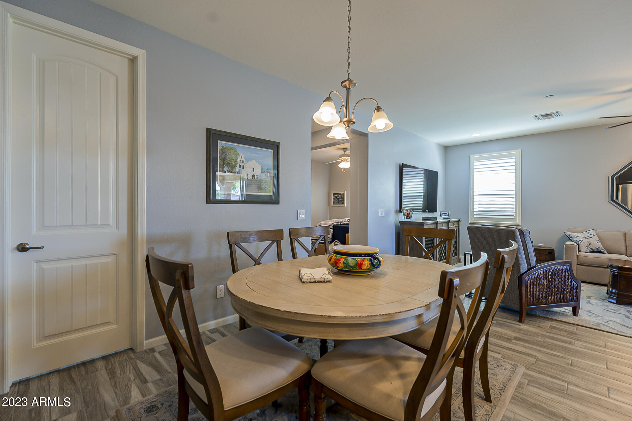 13719 West Linanthus Road Peoria, AZ 85383 - Photo 16 of 38 a view of a dining room with furniture wooden floor and chandelier