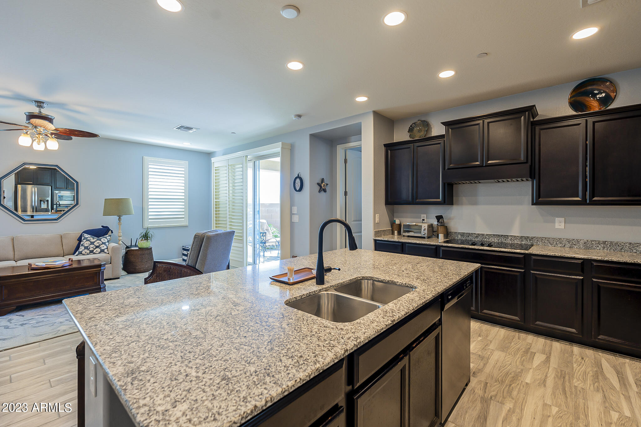 13719 West Linanthus Road Peoria, AZ 85383 - Photo 17 of 38 a kitchen with kitchen island granite countertop a sink stove top oven and refrigerator