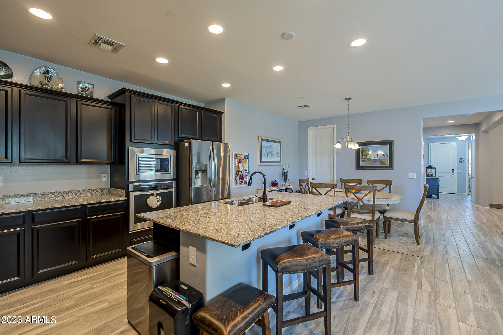 13719 West Linanthus Road Peoria, AZ 85383 - Photo 18 of 38 a large kitchen with a table and chairs