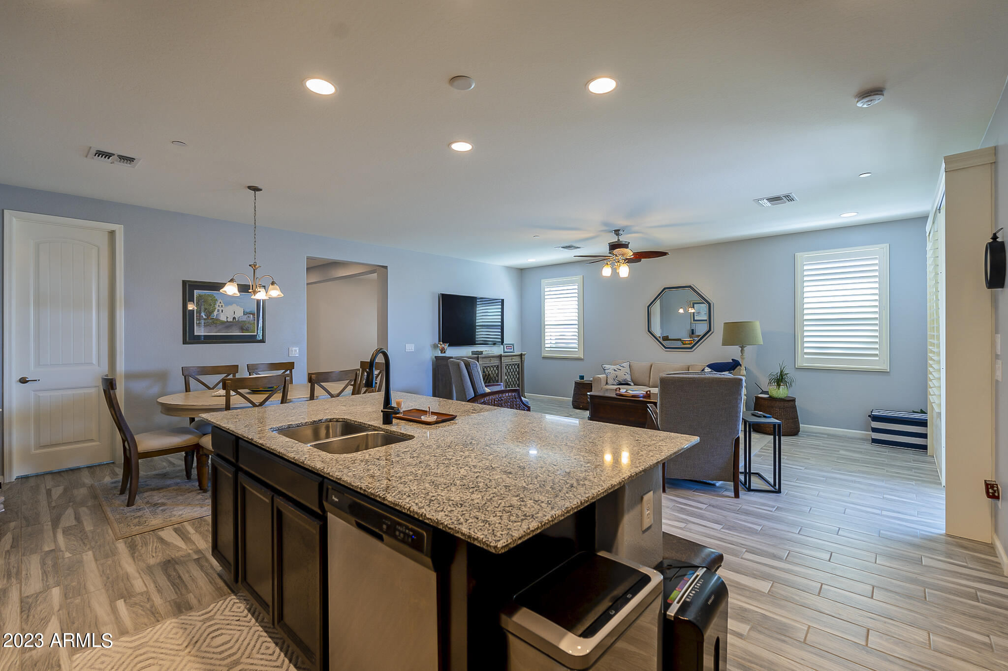 13719 West Linanthus Road Peoria, AZ 85383 - Photo 19 of 38 a view of a dining room with furniture and wooden floor