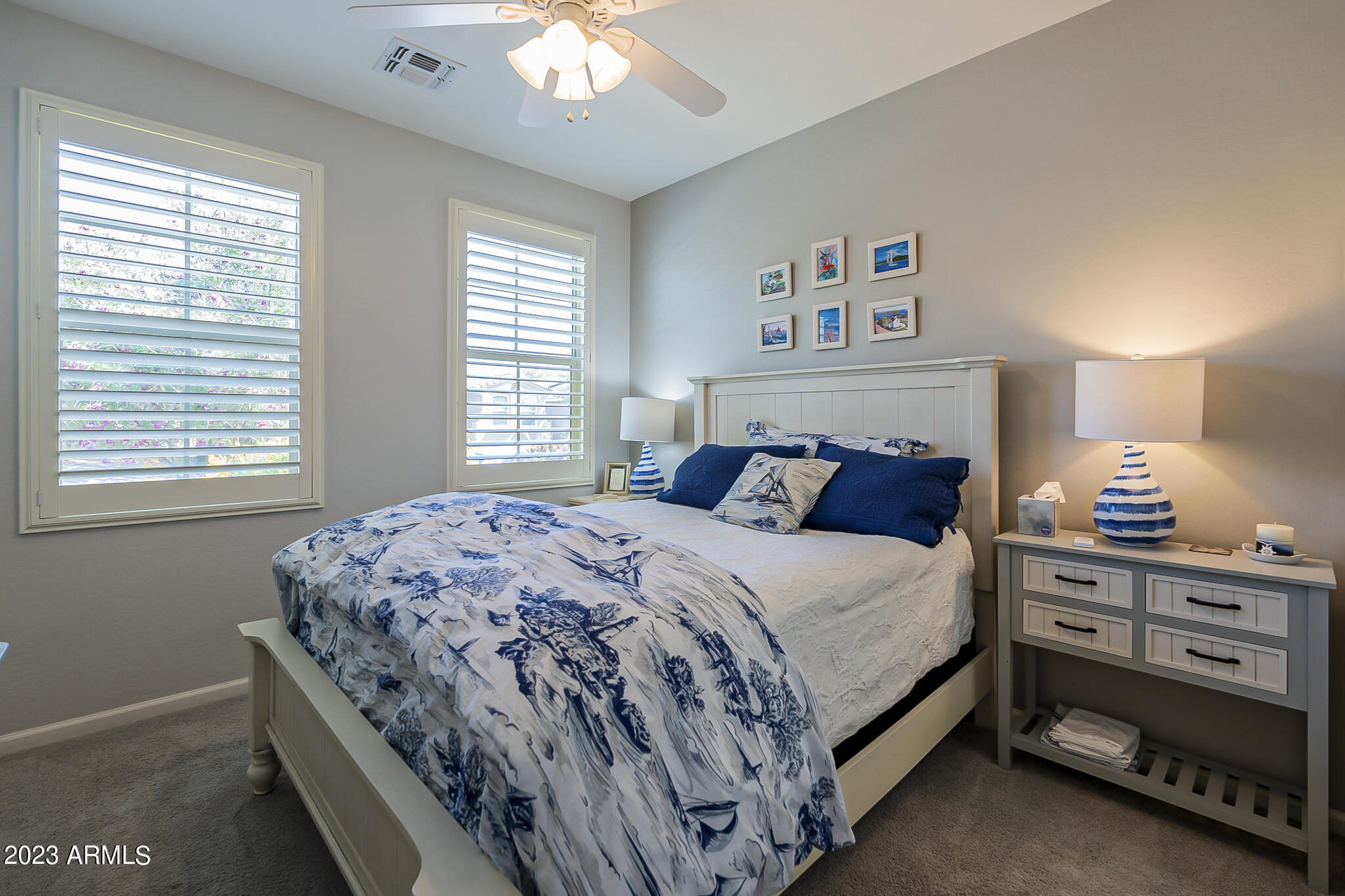 13719 West Linanthus Road Peoria, AZ 85383 - Photo 20 of 38 a bed sitting in a bedroom next to a window
